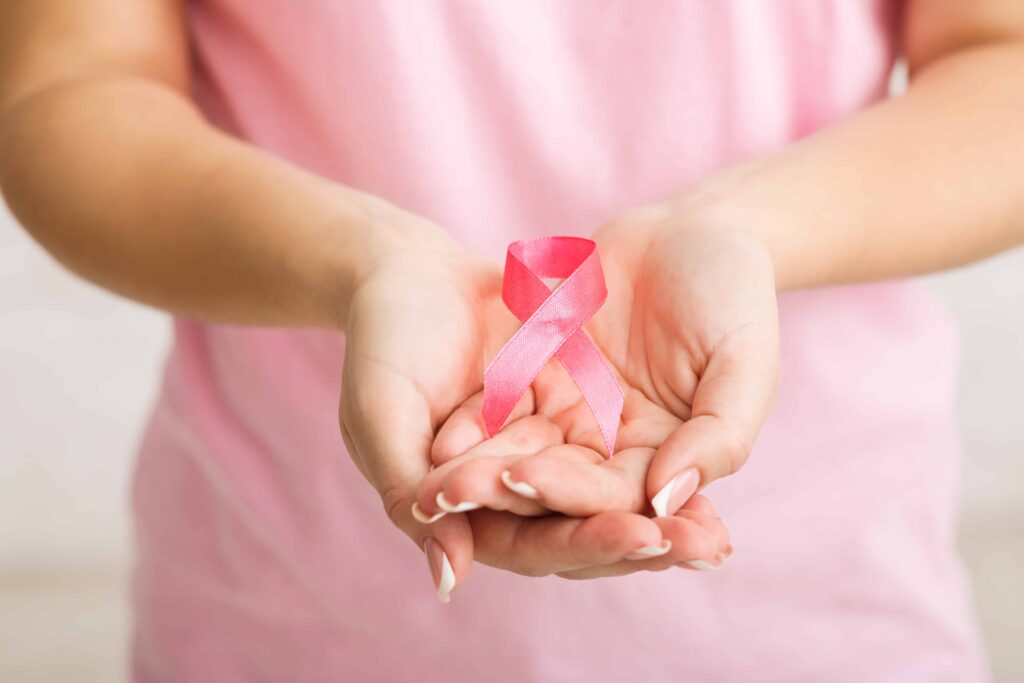 Unrecognizable Girl Holding Pink Ribbon Over White Background, Cropped